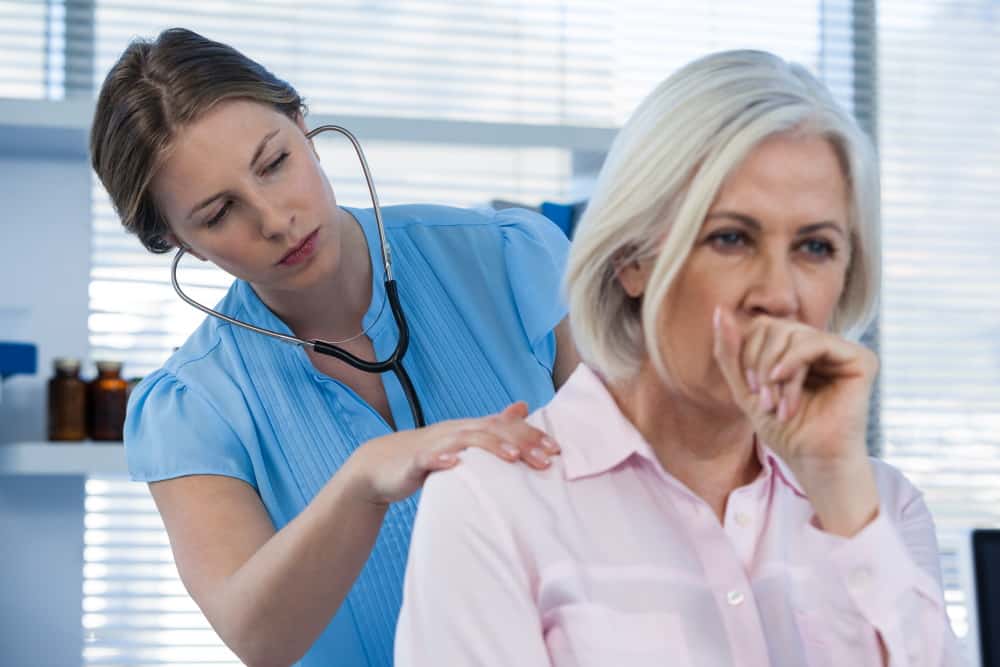 doctor examining coughing patient LTCBV2V