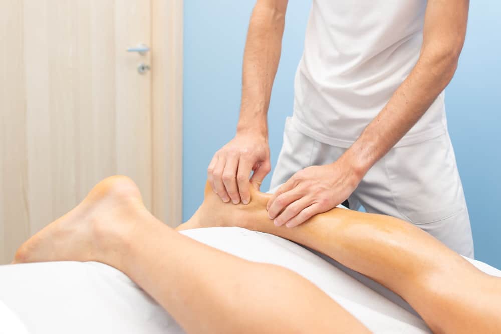 physiotherapist during an achilles tendon treatmen C4Q5ZSU 1