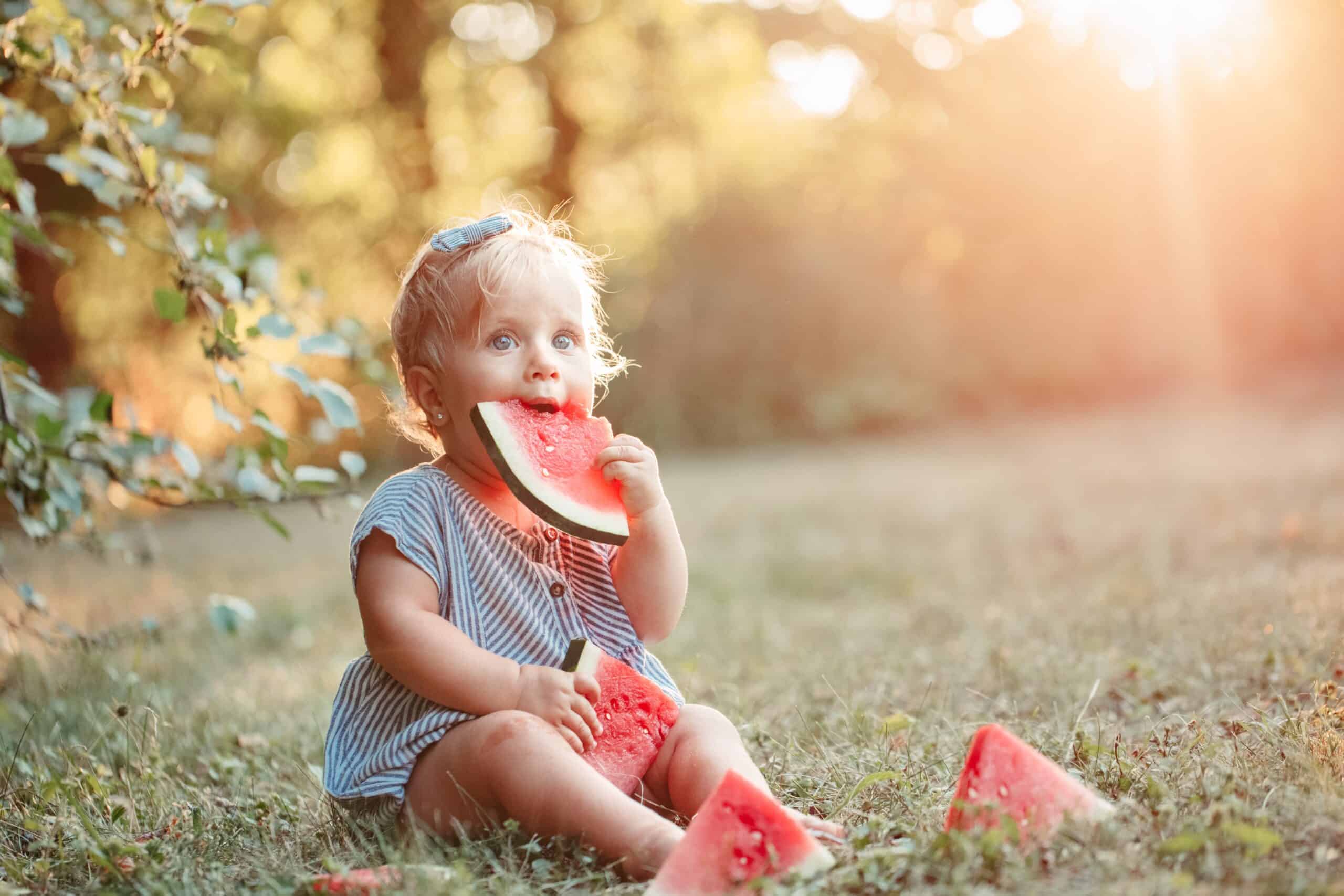 baby girl eating watermelon healthy finger food fo GQTVSQY scaled