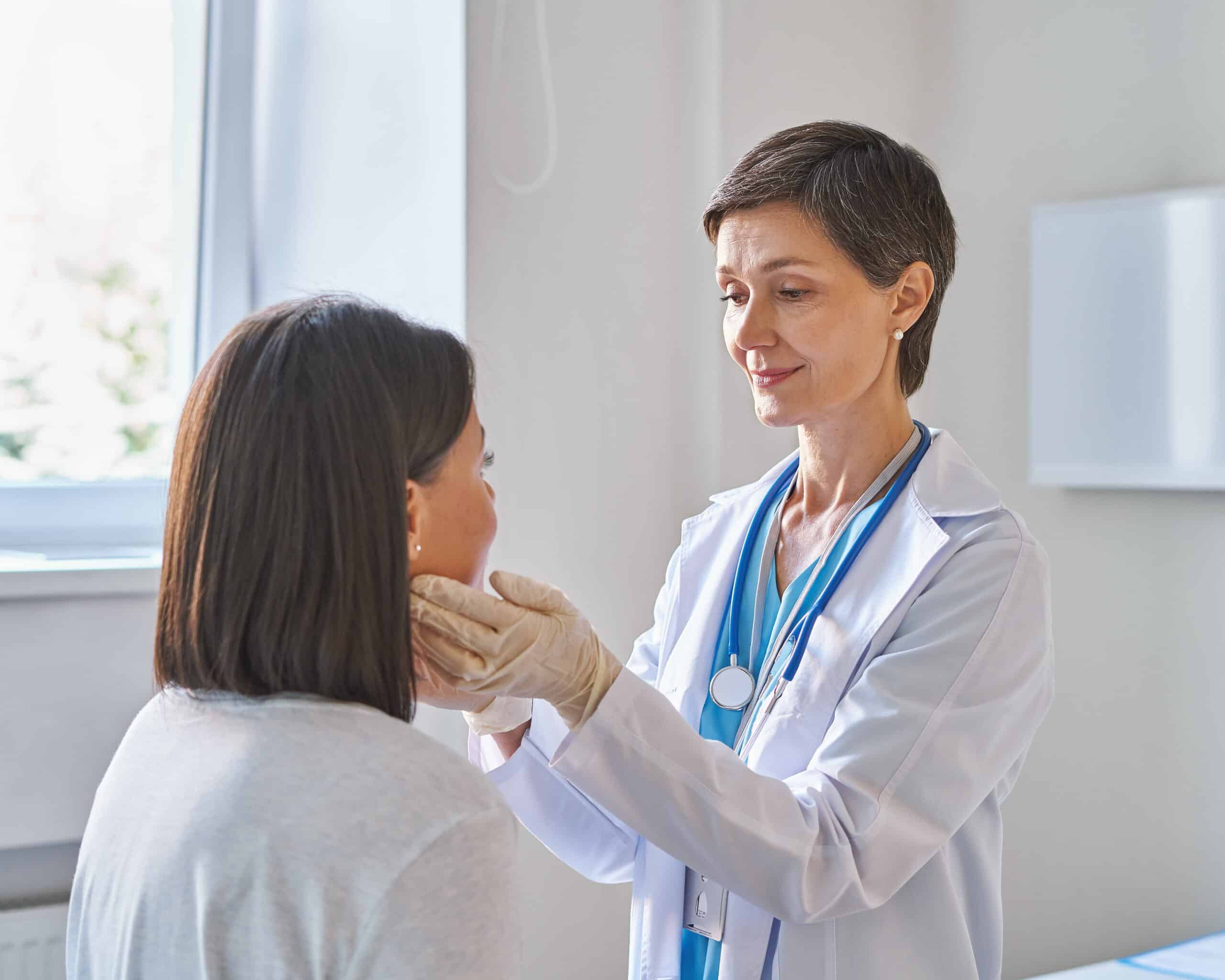 middle aged woman doctor wearing gloves checking p HZFGMVT 1 scaled