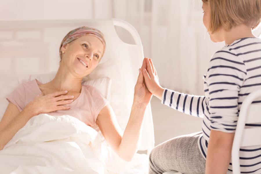 cancer woman touching child s hand 2021 08 26 15 43 51 utc scaled e1641813785702